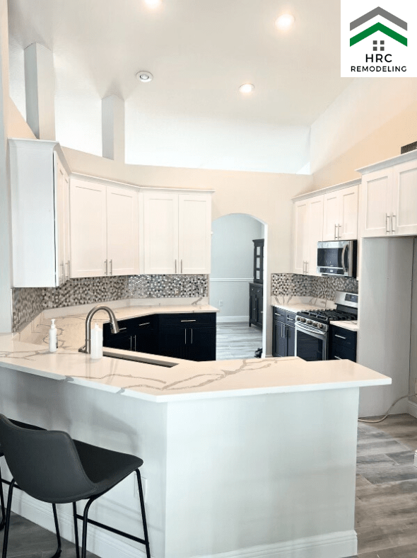 calcutta countertop with white and blue cabinets kitchen renovation