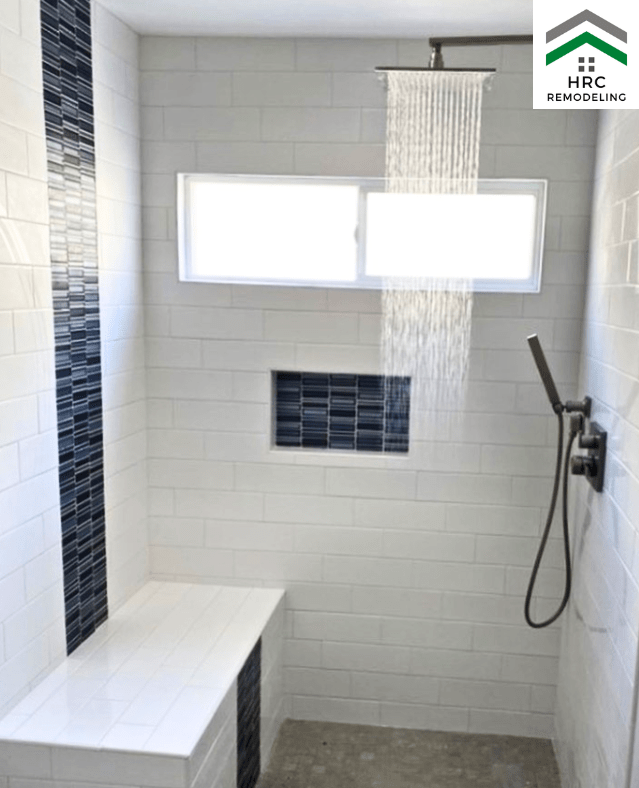 shower bathroom remodel with bench and blue accents
