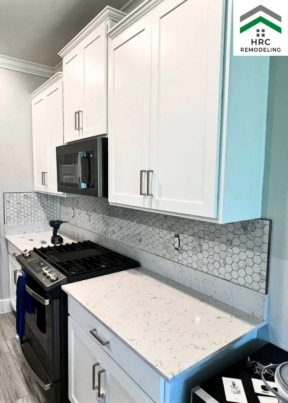 custom hexagon mosaic backsplash with white shaker cabinets brush nickel handles